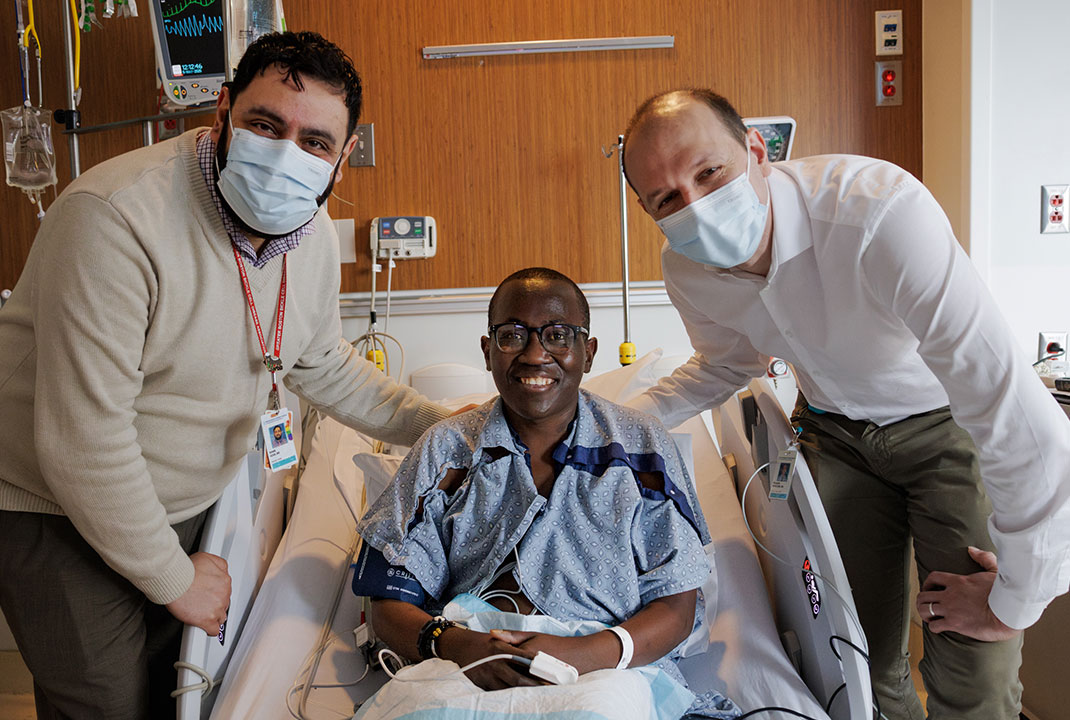 Allan posing with Drs. Azar and Newcomb in the hospital.