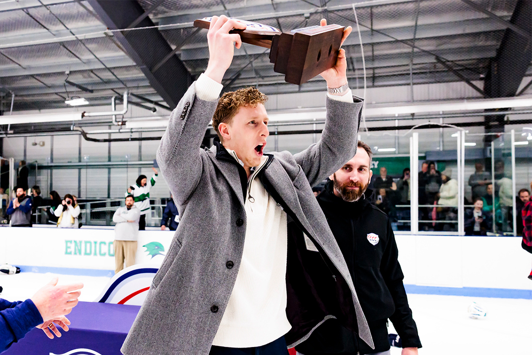 Jack holding a trophy after he and his Endicott Hockey team won the 2024 Commonwealth Coastal Conference championship.
