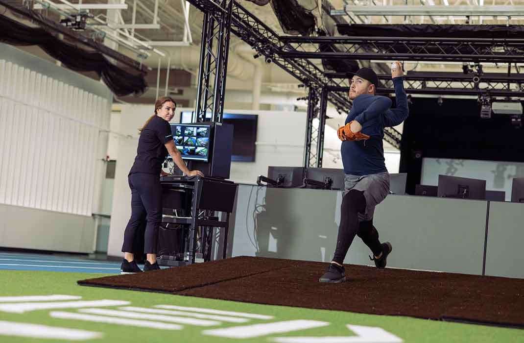 male athelte throwing a baseball during a biomechanical pitching assessment