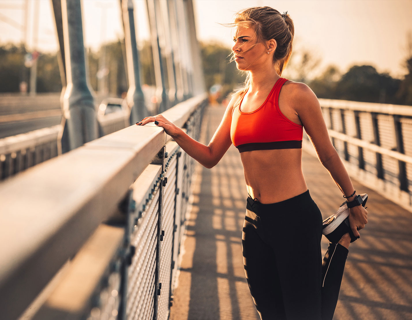 woman stretching her leg outdoors while standing