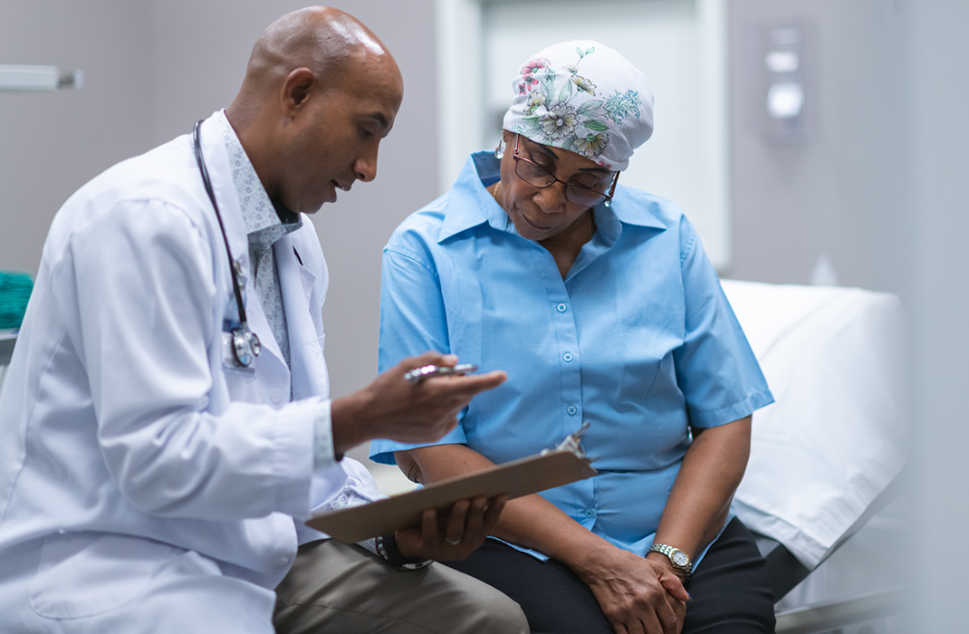 male doctor with female patient at bedside